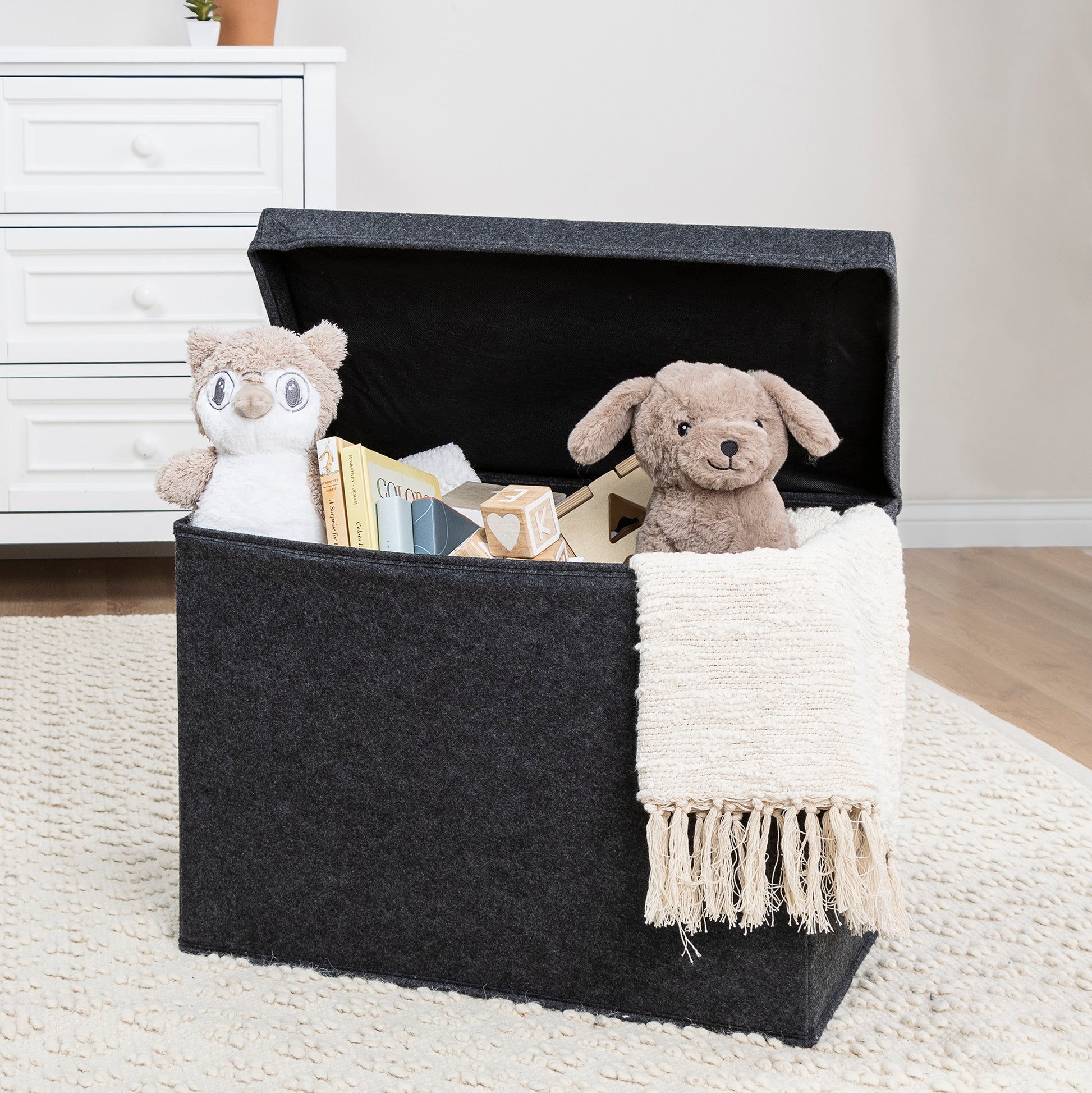 Charcoal Gray Felt Toy Box by Sammy & Lou® with lid open with toys and stuffed animals peeking out