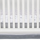 Crib skirt fits standard crib mattress 28 in x 52 in with 14-inch drop and features a top panel of glacier gray with a white stripe and dash print separating the bottom panel of paloma gray.