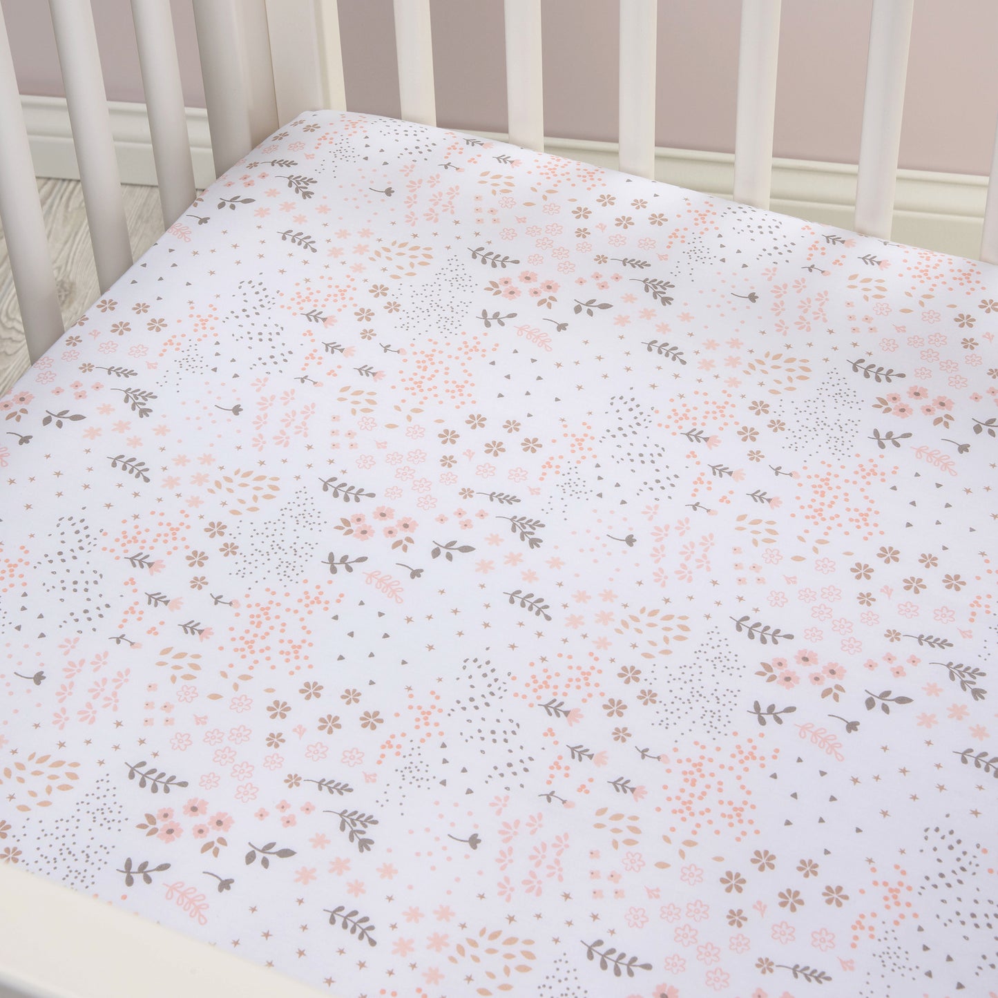 Blush Floral Fitted Crib Sheet - stylized corner view on crib
