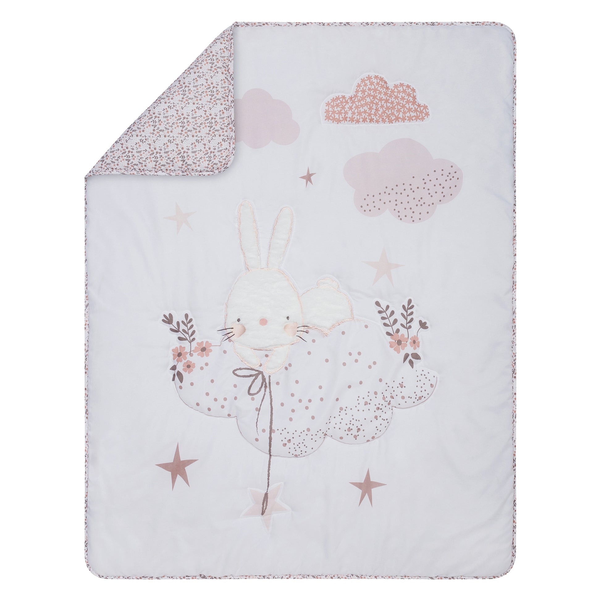 Nursery Crib Quilt Features an adorable bunny rests among the clouds and stars which are accented by floral and dot prints in a soft color palette of soft pinks and gray on a clean white background. 