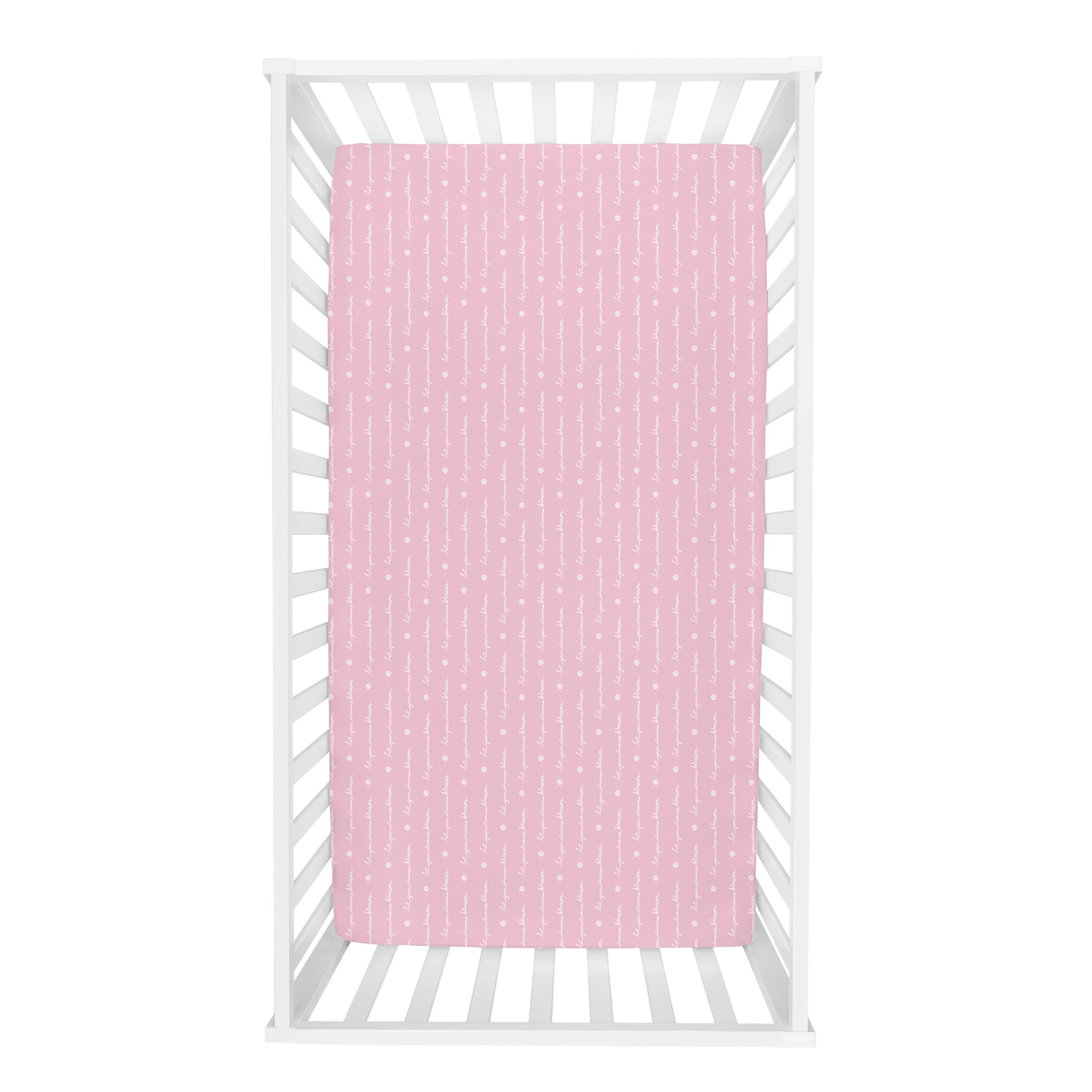 Floral 2-Pack Microfiber Fitted Crib Sheet by Sammy & Lou®; overhead view features “let your dreams blossom” script print in white on a light pink background.