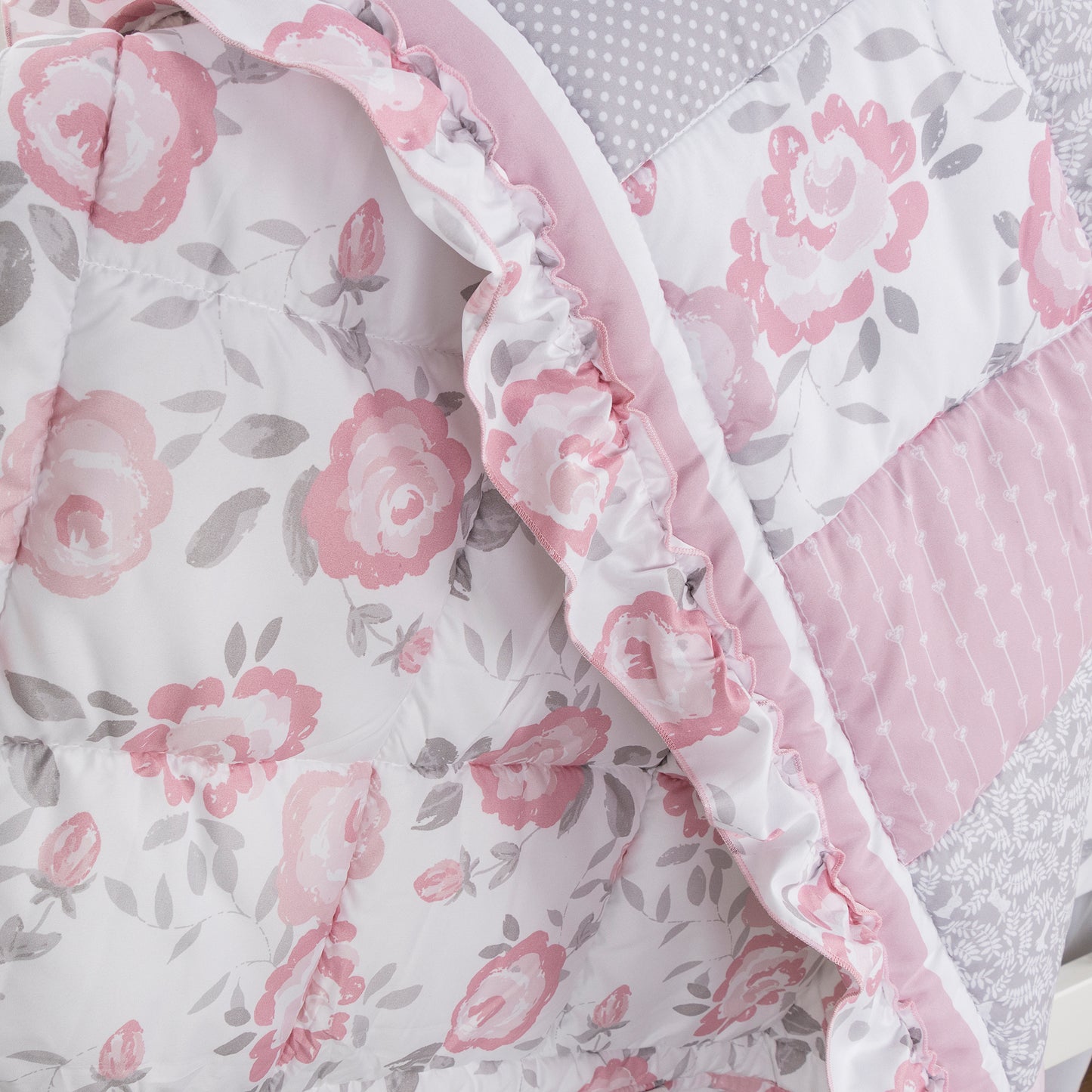 Emma 4 Piece Crib Bedding Collection by Sammy and Lou; stylized fabric details of nursery quilt