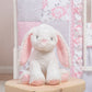 Emma 4 Piece Crib Bedding Collection by Sammy and Lou; stylized image of adorable bunny plush toy which measures 9 inches tall
