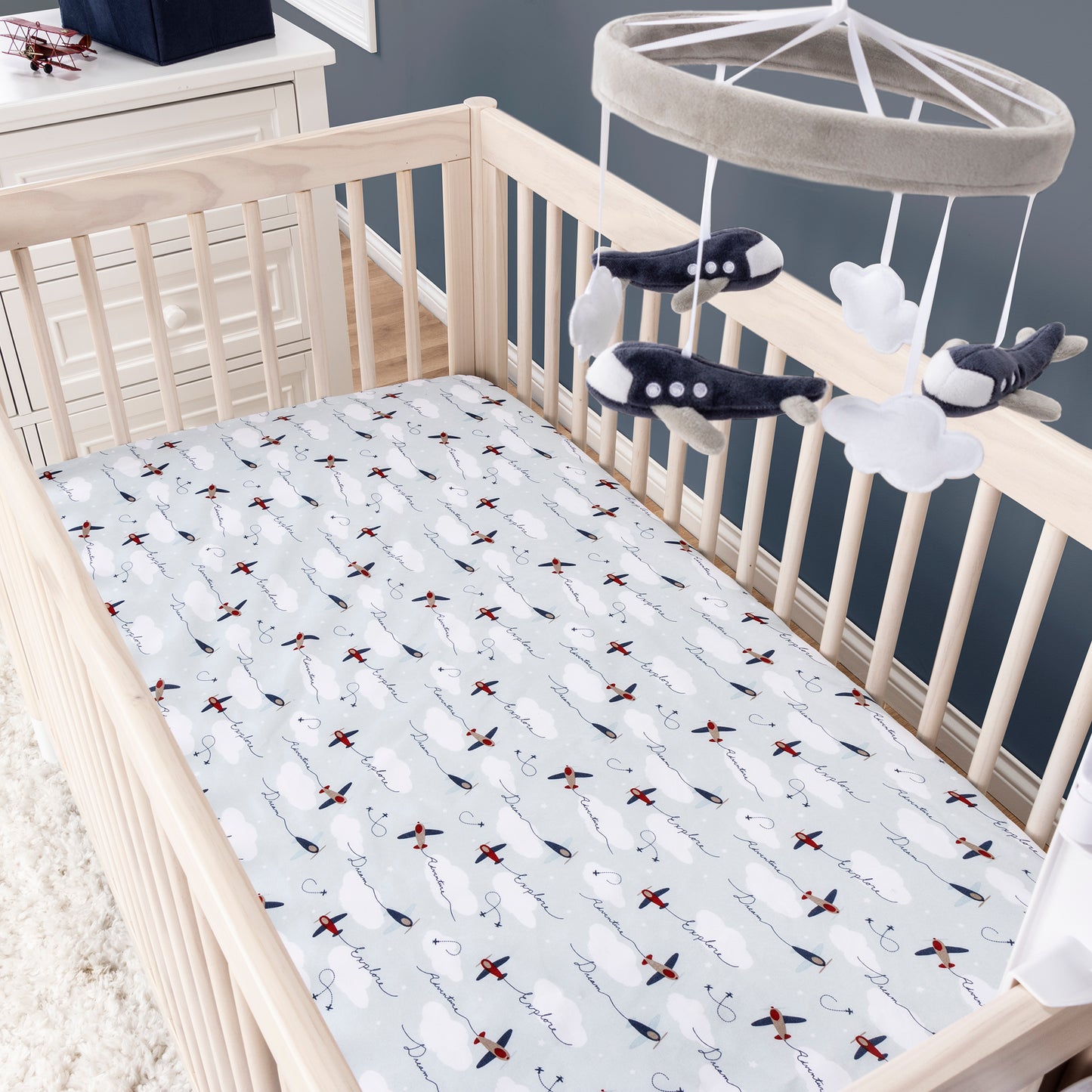 Airplane Musical Crib Baby Mobile by Sammy & Lou®- stylized image of the navy airplane mobile with the airplanes crib sheet on crib