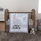 Cottage Farm 4 Piece Crib Bedding Set main image in stylized room; Bedding set features a cow, sheep, pig, and chicken out playing in a simple pasture. Grays, browns and a rosy pink color scheme will add the perfect last touch to your little farmer's nur