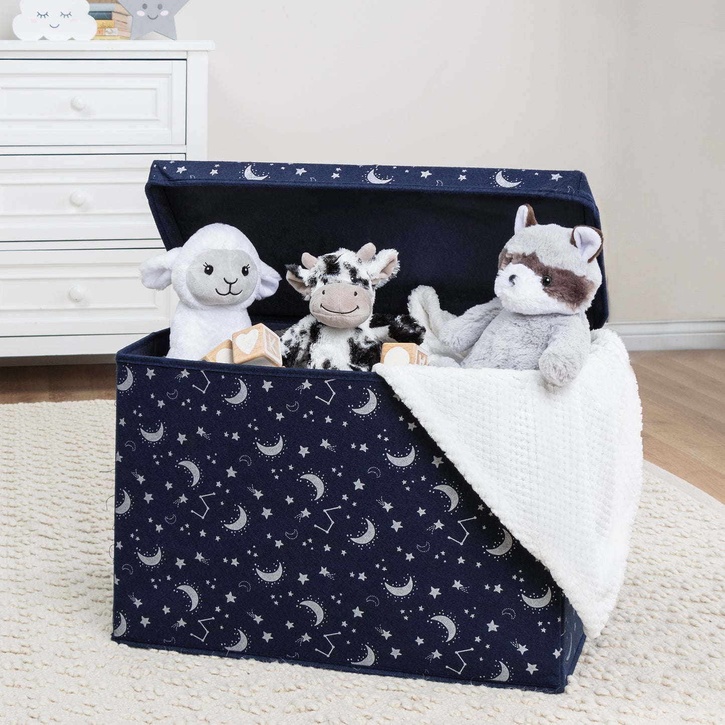 Constellation Felt Toy Box by Sammy & Lou® with lid open with toys and stuffed animals peeking out