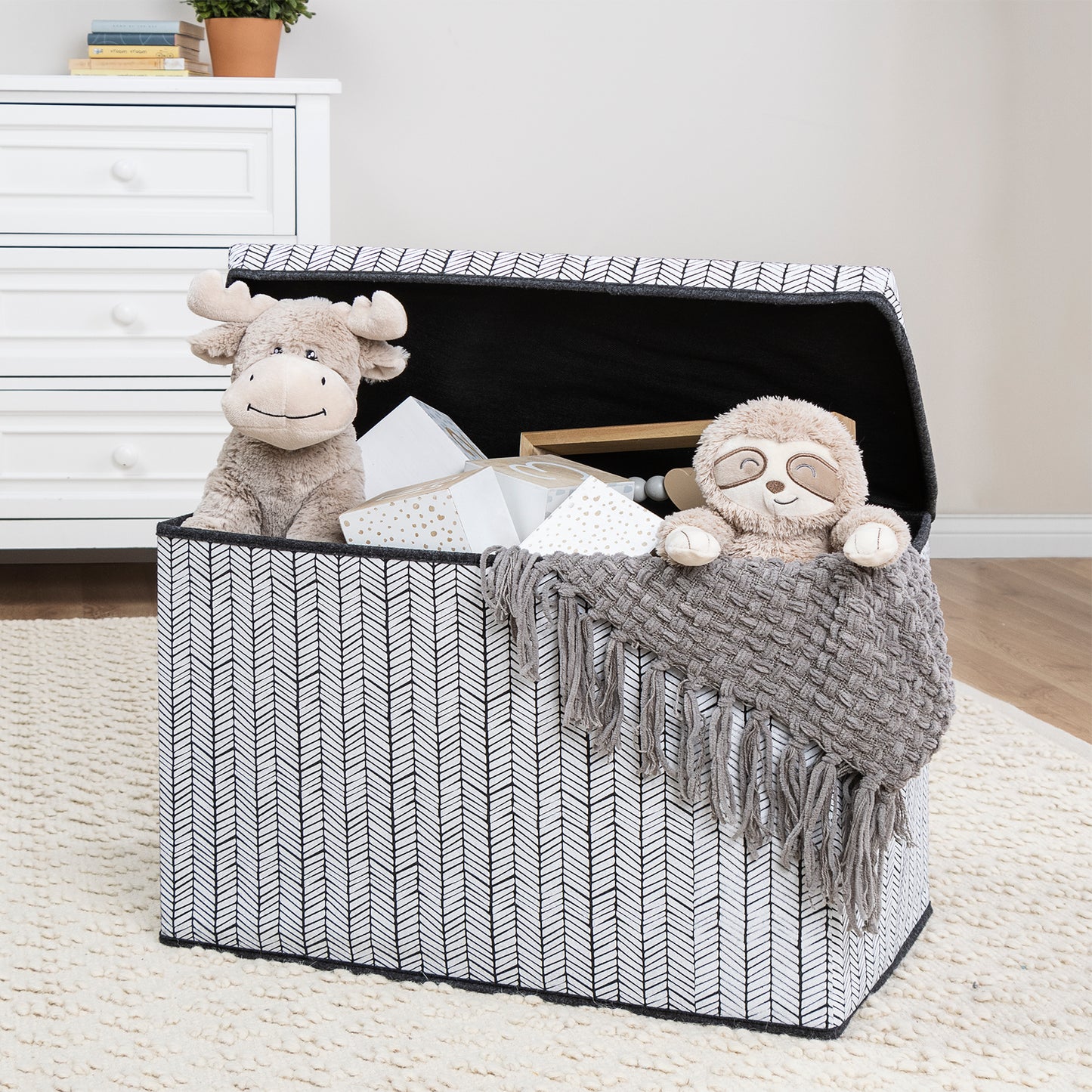 Herringbone Felt Toy Box by Sammy & Lou® with lid open with toys and stuffed animals peeking out