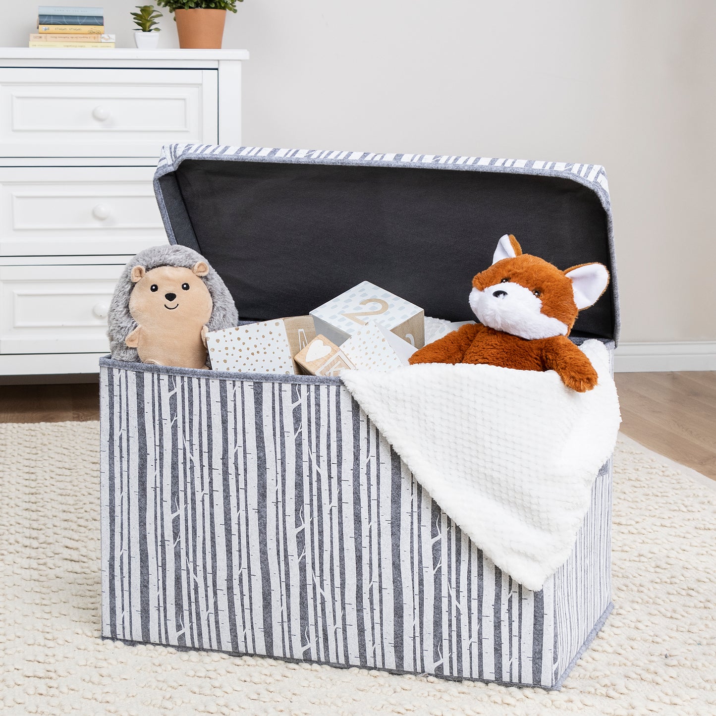Birch Felt Toy Box by Sammy & Lou® with lid open with toys and stuffed animals peeking out