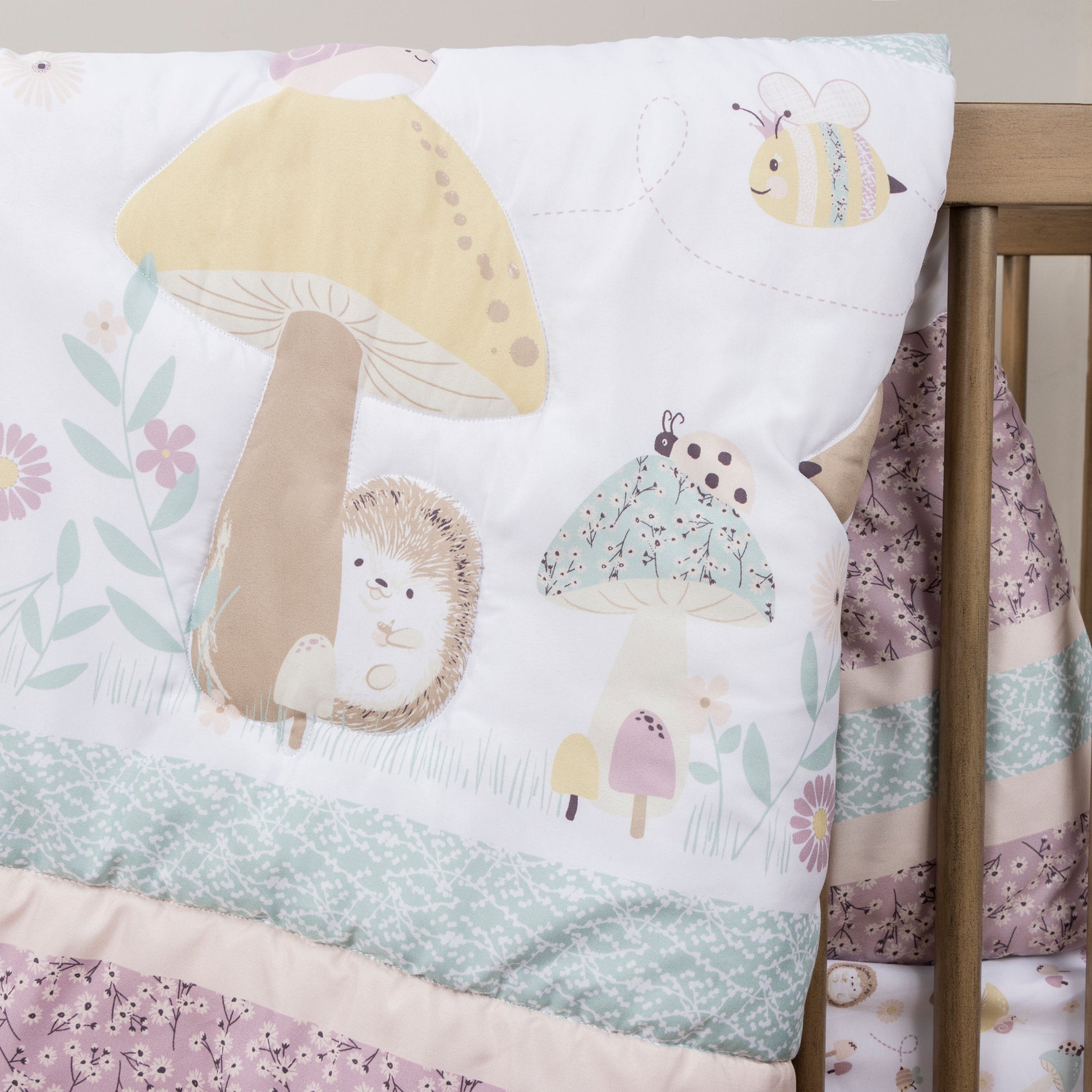  Enchanted Garden 4 Piece Crib Bedding Set by Sammy & Lou®; stylized fabric detail image featuring woodland animals and mushrooms