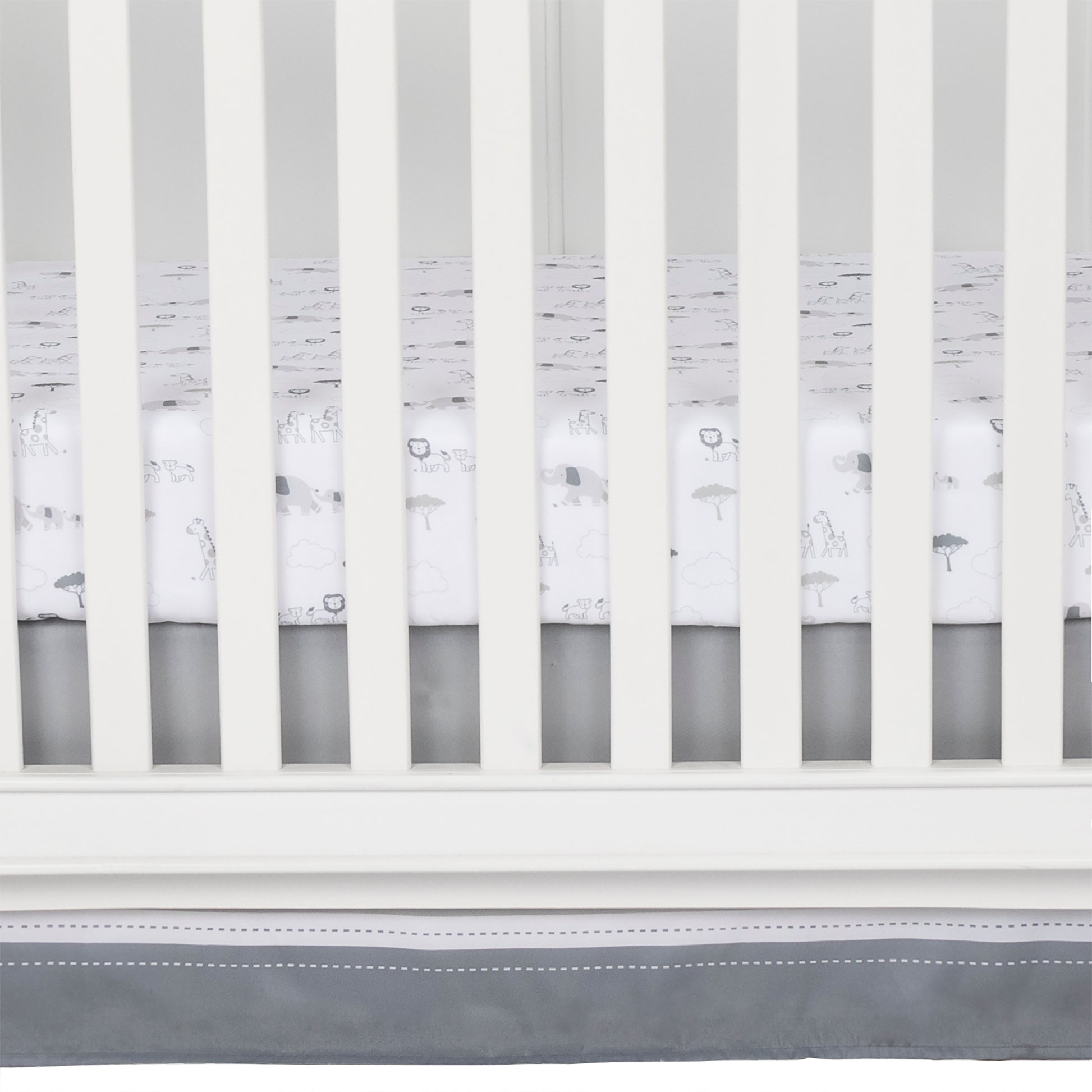 Crib skirt fits standard crib mattress 28 in x 52 in with 14-inch drop and features a top panel of glacier gray with a white stripe and dash print separating the bottom panel of paloma gray.