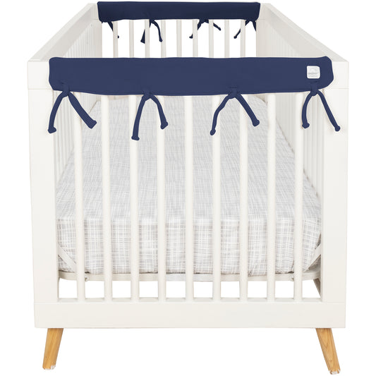 CribWrap® Narrow 2 Short Navy Fleece Rail Covers on a white crib