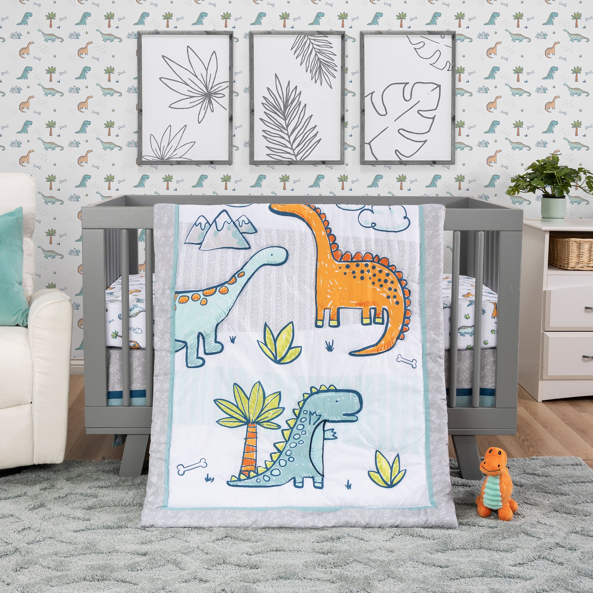 Dinosaur Million Years 4 Piece Crib Bedding Set by Sammy & Lou® in stylized bedroom. The collection features three prehistoric dinosaur friends in fun bright colors of aqua, orange, and green.