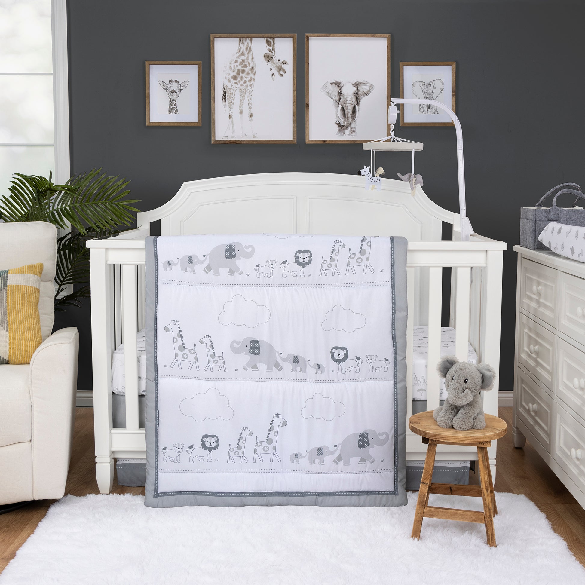 Follow the Leader 4 Piece Crib Bedding Set by Sammy & Lou. This collection features gray baby and grown lions, giraffes and elephants following each other through the dessert. A dashed bedtime gray inner border and a glacier gray outer border frames this set to match any nursery