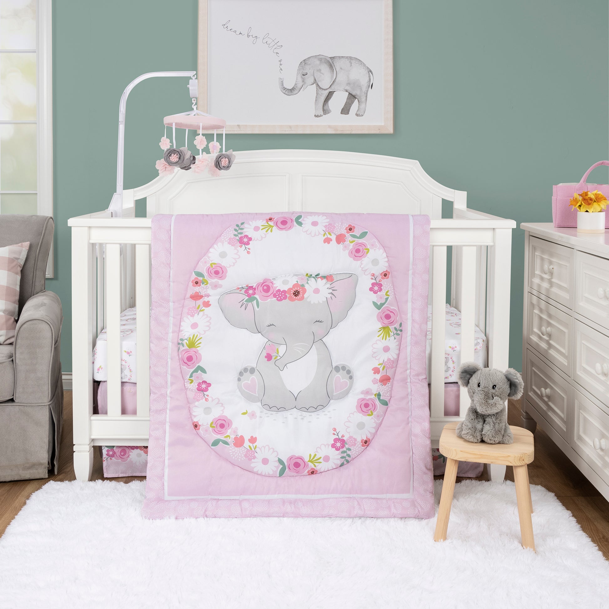 Elephant Garden 4 Piece Crib Bedding Set by Sammy & Lou® in stylized bedroom. Set includes a nursery quilt / playmat, fitted crib sheet, crib skirt, and elephant plush toy.