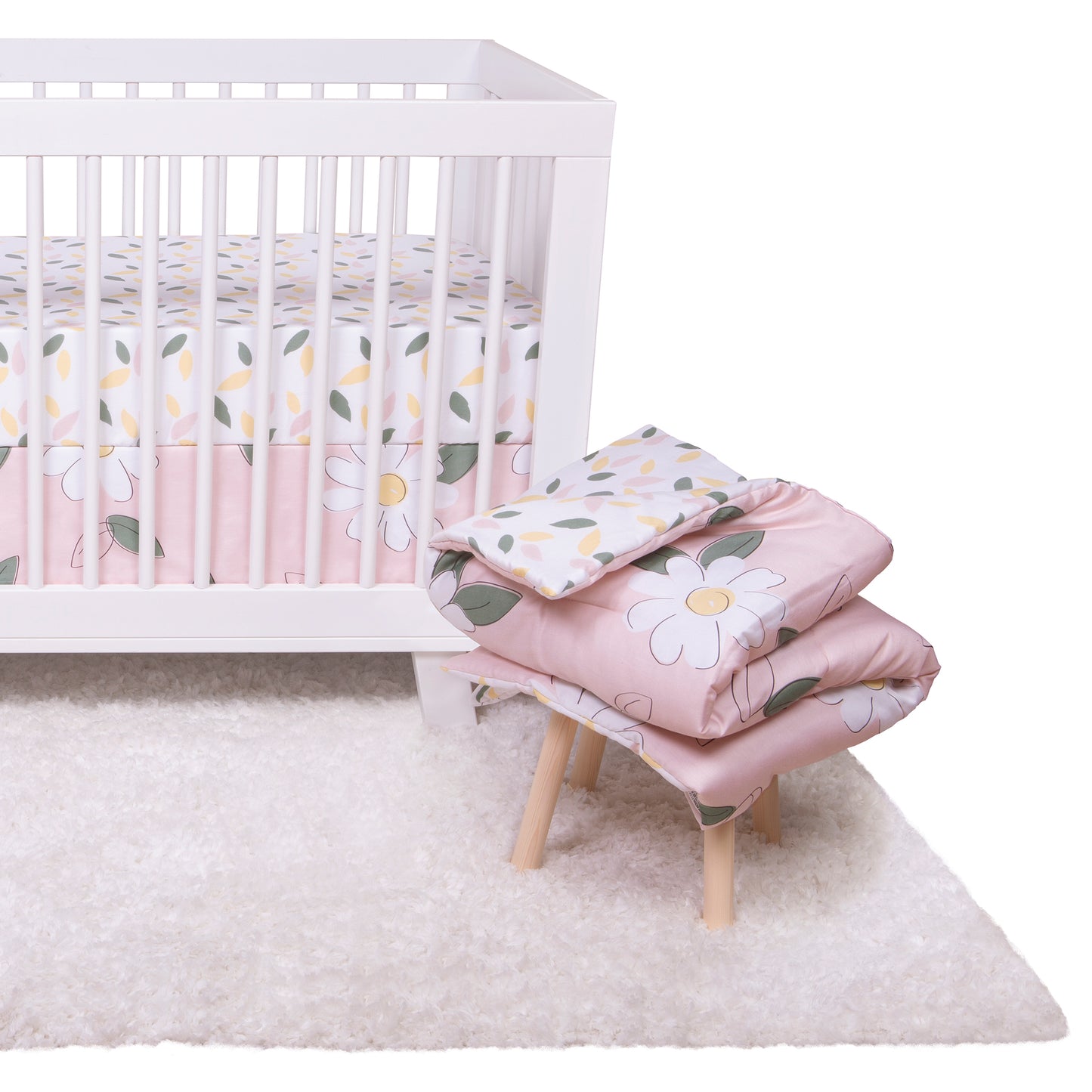Lemon Floral Bedding Set with Main Crib Sheet and Skirt on a crib, and the quilt on a stool next to the crib